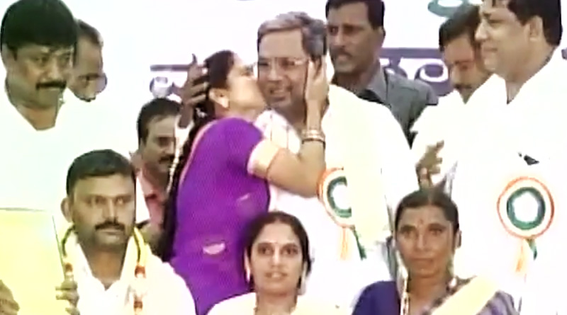 A woman kisses Karnataka CM Siddaramaiah during a state-level program