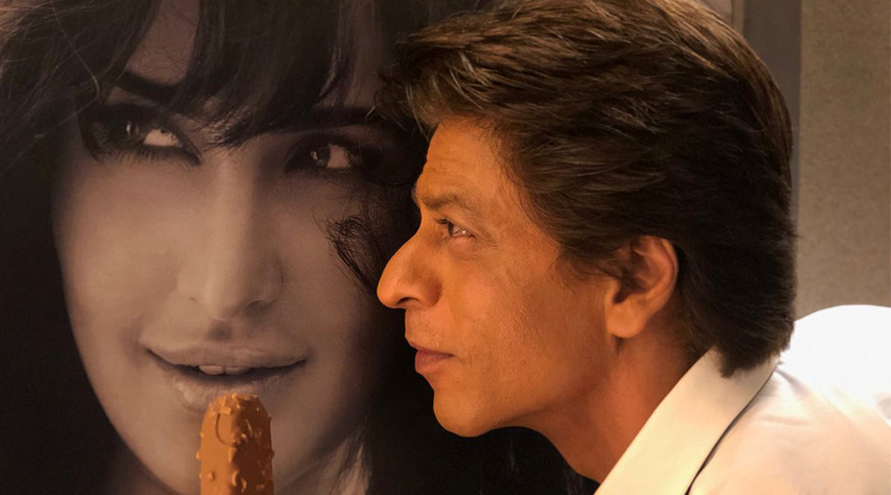 Shah Rukh Khan poses with an ice cream in front of Katrina Kaif's poster