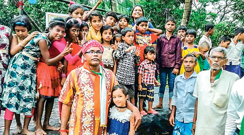 Tamluk:  group Of people give cloth to the poor For Puja