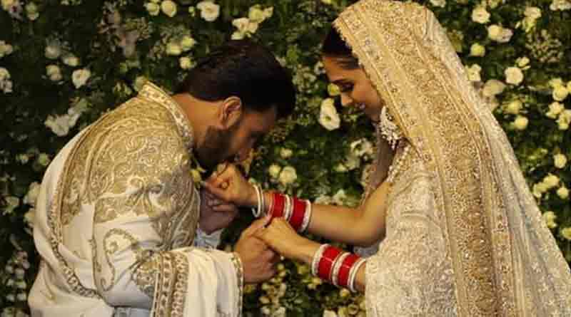 Husband Ranveer carries wife Deepika's shoe at a wedding ceremony