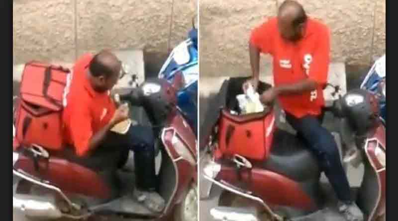 Zomato delivery boy having food from packet