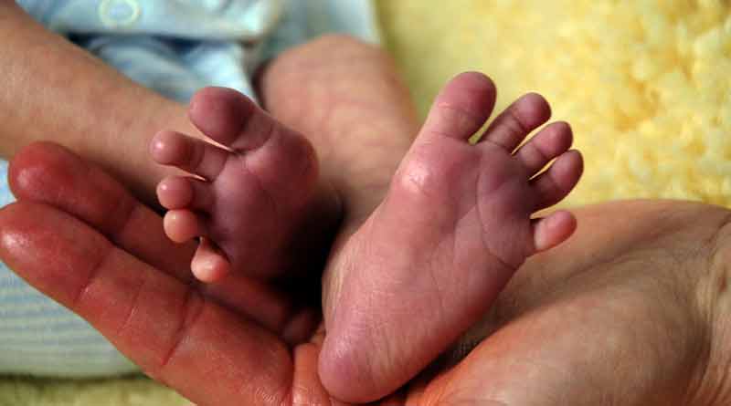 Pregnant devotee births in the Ganges