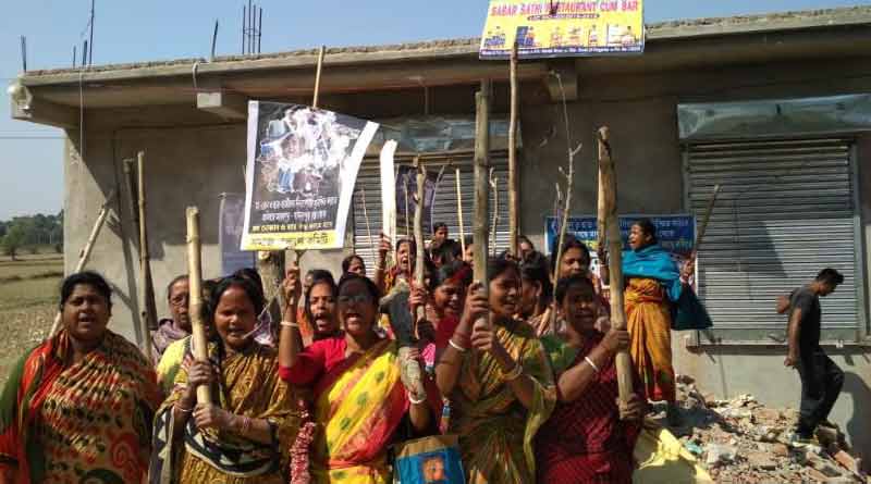locals protest to close liquor shop 