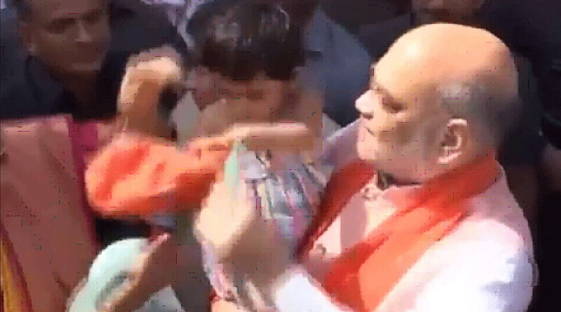 Amit Shah tries to make granddaughter wear BJP hat. She is not amused.
