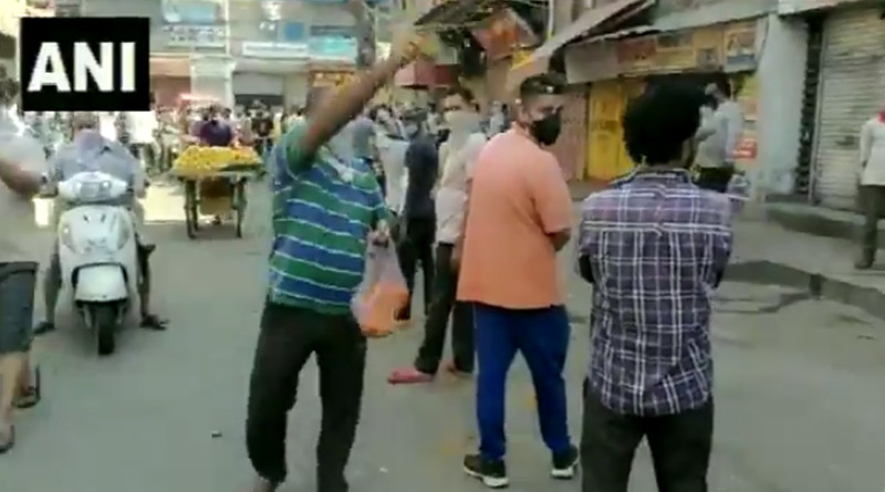 Man showers petals on people standing in queue outside liquor shops