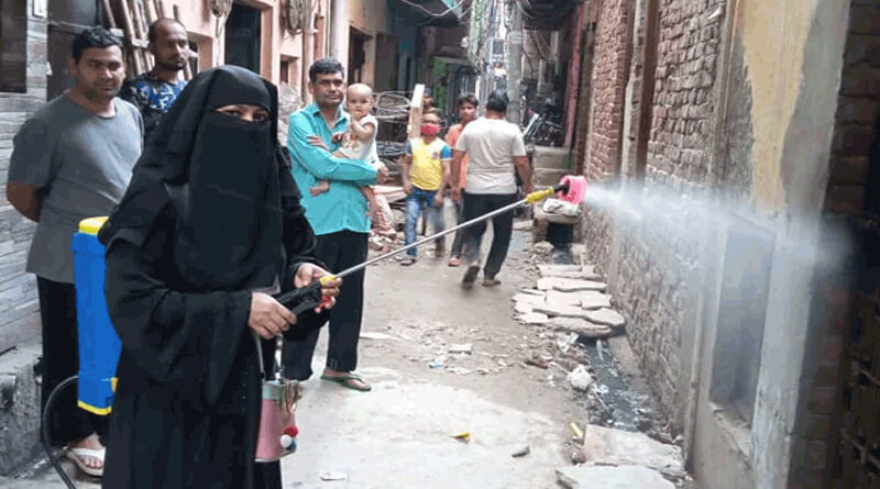 Corona Warriors sanitise Delhi temple in Burqa, priest helps her