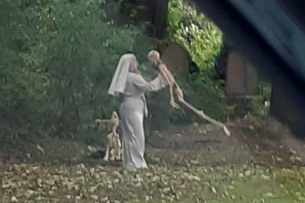 Nun dances with skeleton