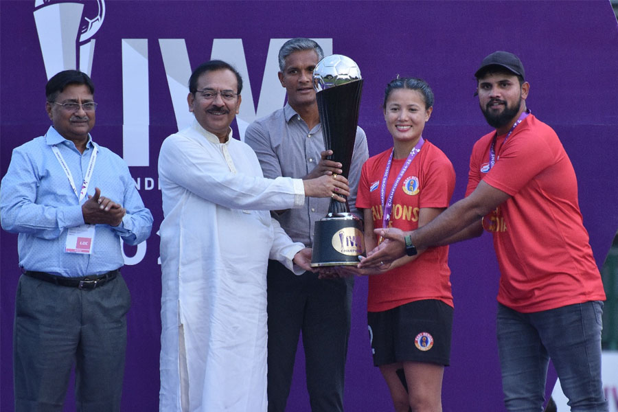 Sports Minister Arup Biswas receives the IWL trophy on behalf of East Bengal